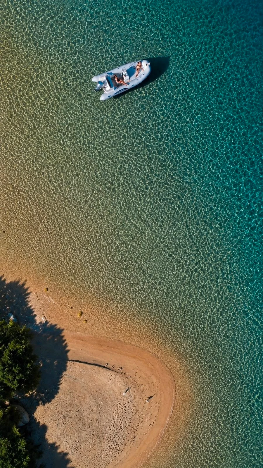RIB by a pale-sand beach in the La Maddalena archipelago