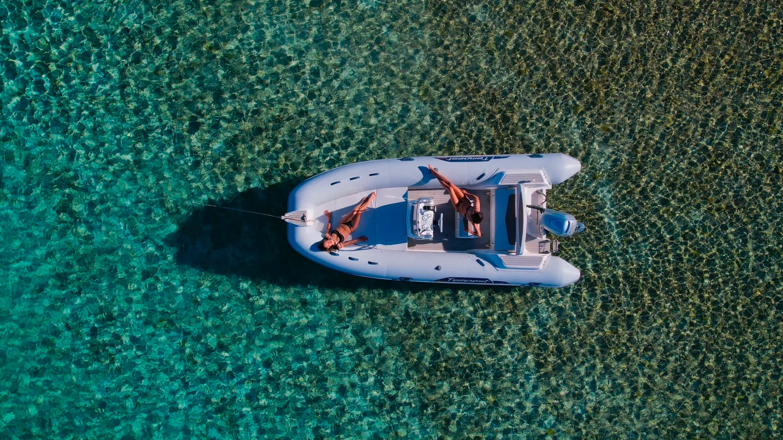 Aerial top-down view of the Capelli Tempest 570 RIB on the crystal-clear turquoise waters of La Maddalena