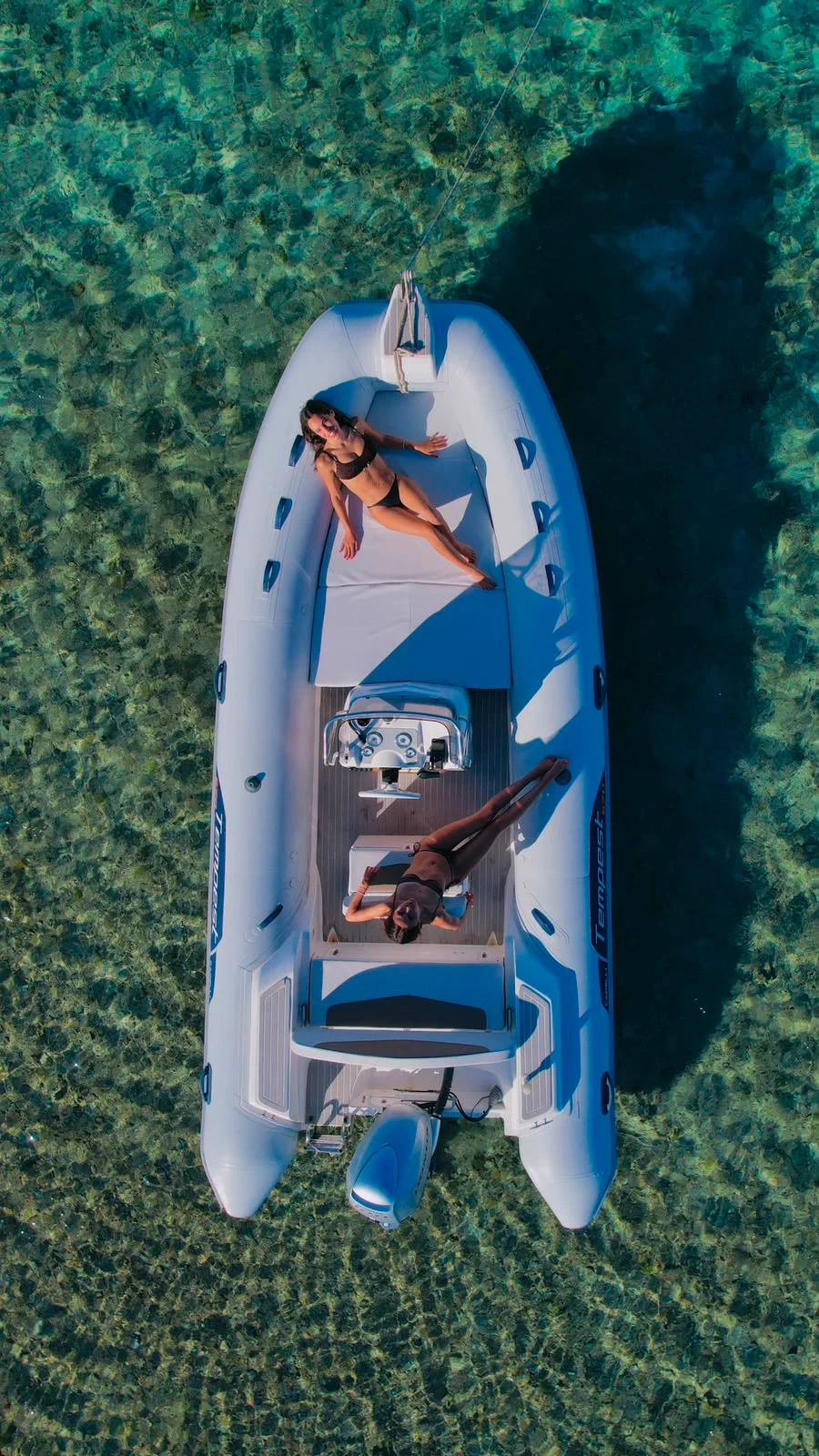 The Capelli Tempest 570 sun pad seen from above over turquoise water